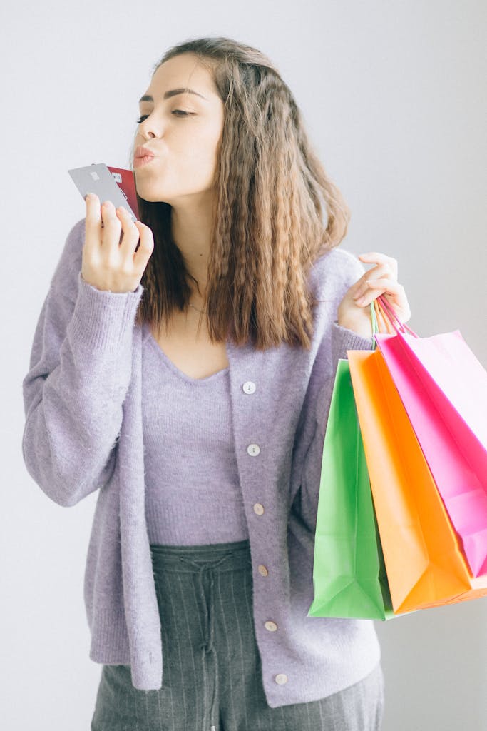 A Woman Holding Paper Bags and Cards